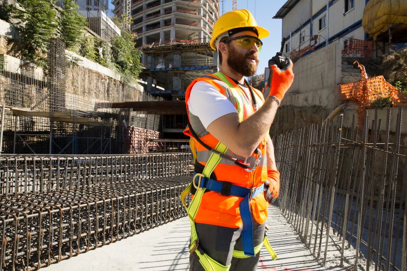 Workers Wearing Smart Helmets and Vests for Construction Safety at Advanced Building Corporation
